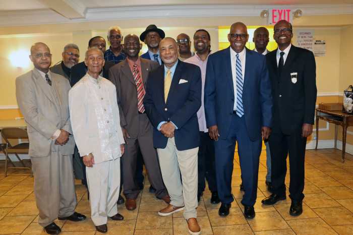 Pastor Rev. Roger Jackson, second from right, front, with fathers at reception after Father's Day Service.